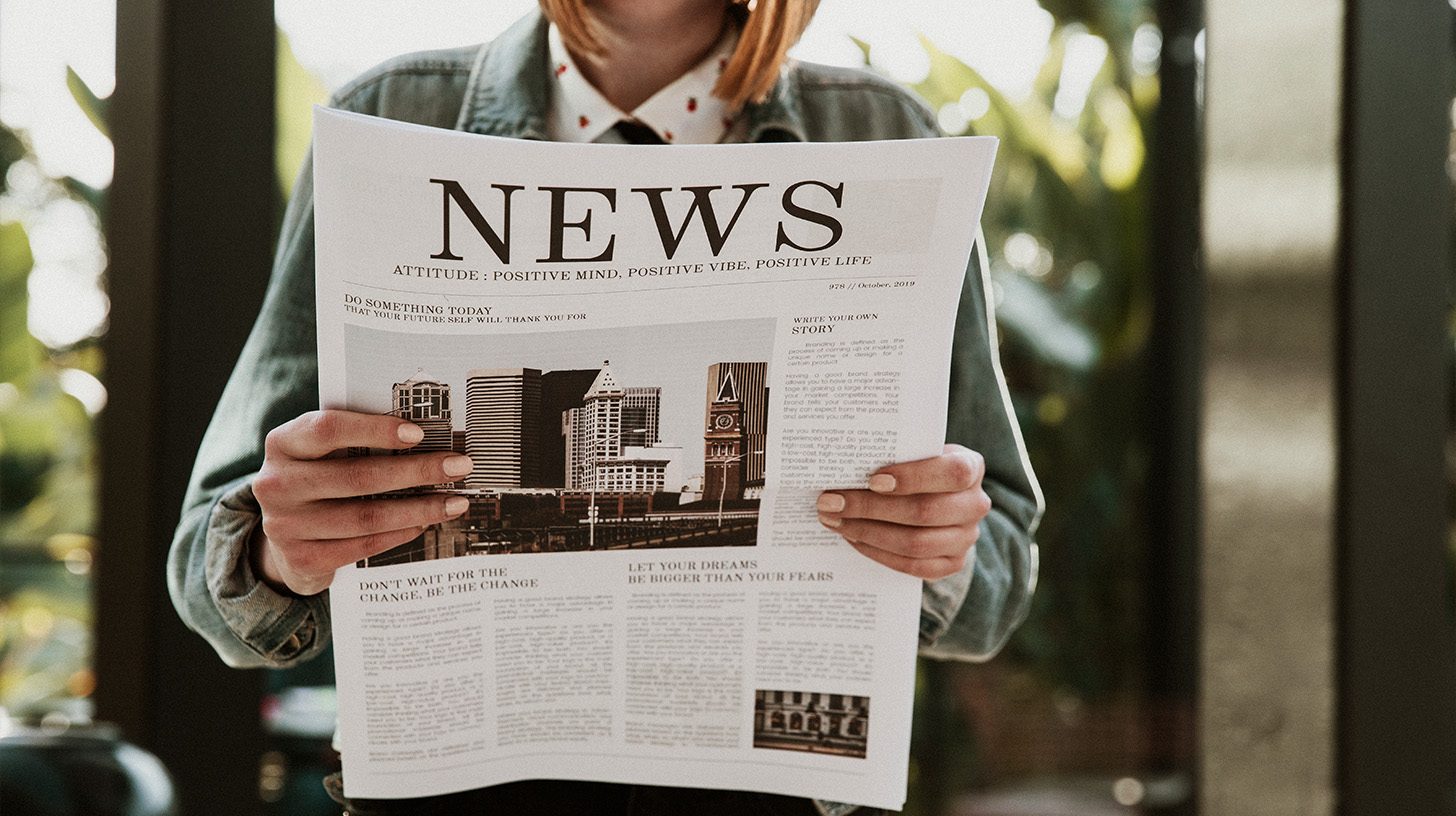 lady reading press release in newspaper