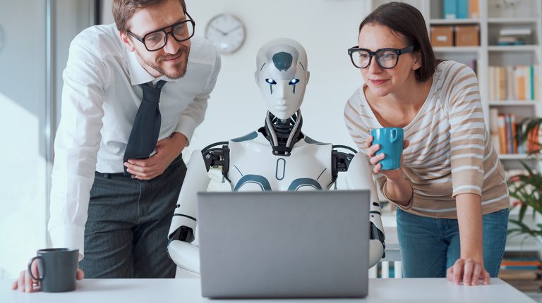 robot reading a laptop computer with two people